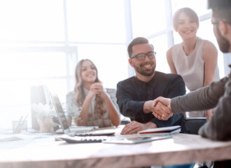 Team collaborating in office on managed services