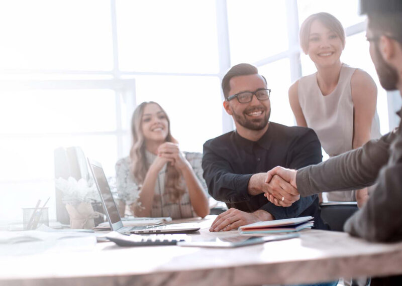 Team collaborating in office on managed services