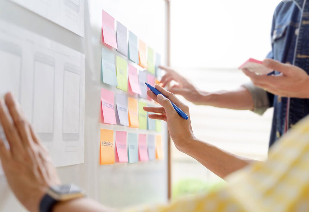 Web designer working together with UX and UI in studio office.