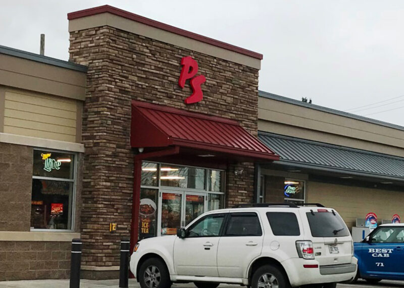 View of vehicles parked outside PS food mart