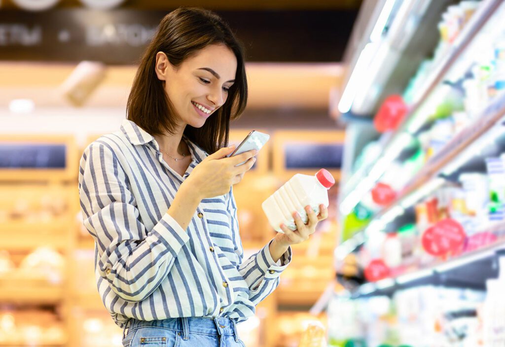 Woman scanning code on products using smartphone