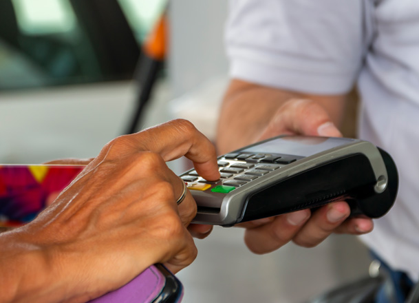 Person using a mobile device to make a payment at a convenience store 