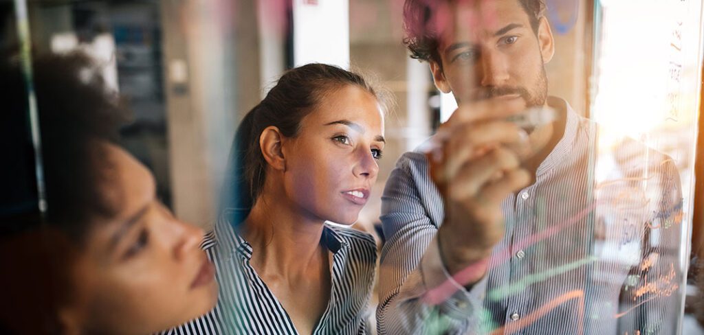 Programmers collaborating to develop analytics and insights apps at IT company.