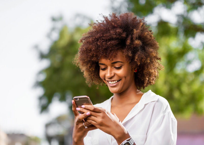 Woman holding and looking at mobile phone