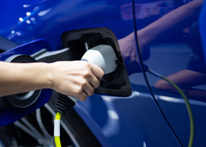 EV charging handle for electric cars in green energy and eco energy concept to reduce CO2 emissions