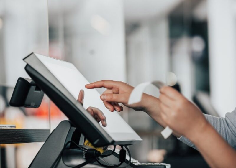 A person operating a point of sale system