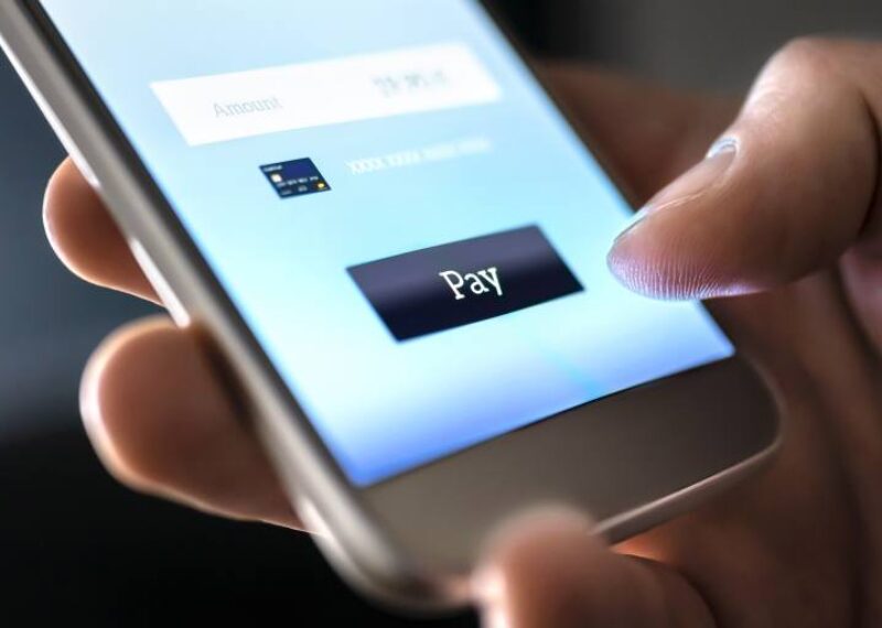A person making a payment on a cell phone