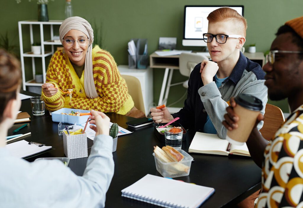 Creative team collaborating aroud table at office .