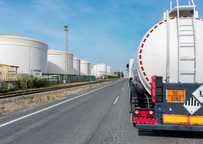 photo of a fuel truck from behind driving down the highway