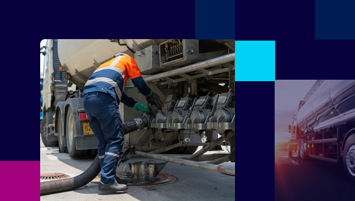 Fuel delivery driver attaching hose to fuel logistics truck