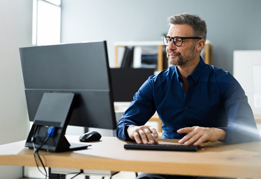 Businessman Using Business Computer In Office