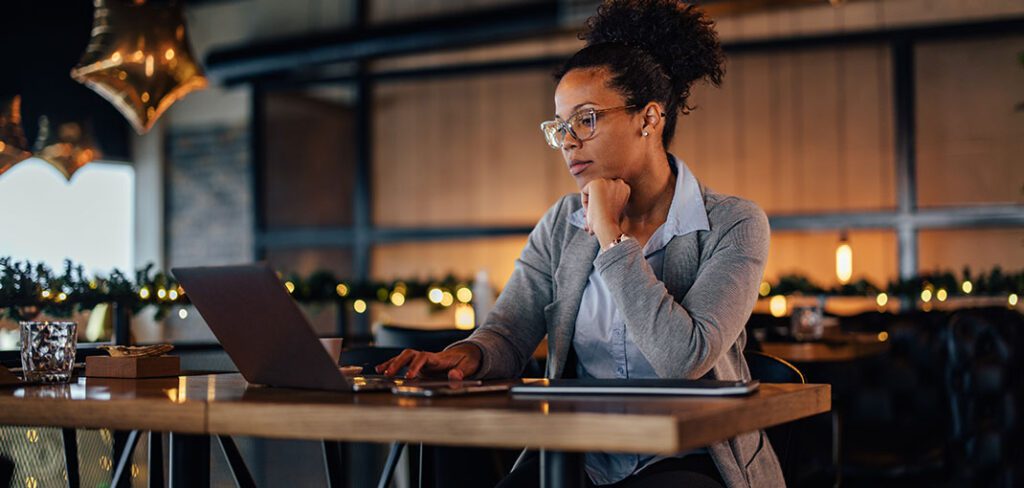 Woman sitting at desk working on office computer.