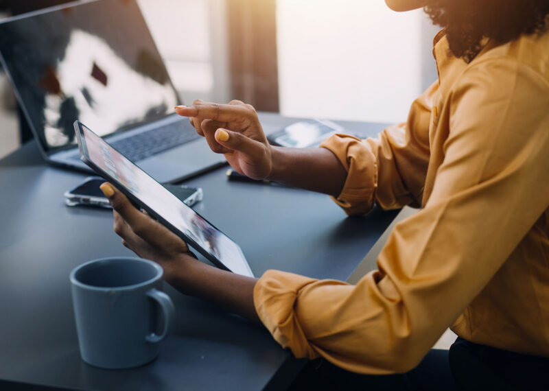 women processing accounts payable payments on tablet and laptop computer