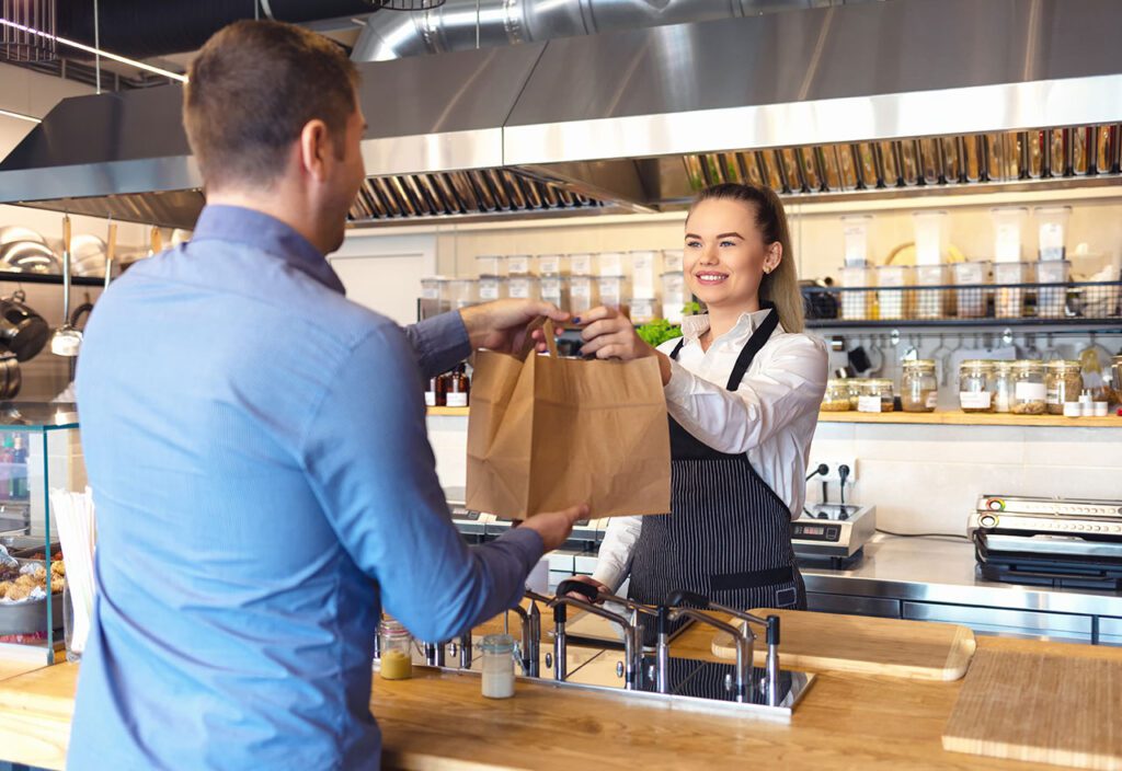 Self-service desk with touch screen in fast food restaurant