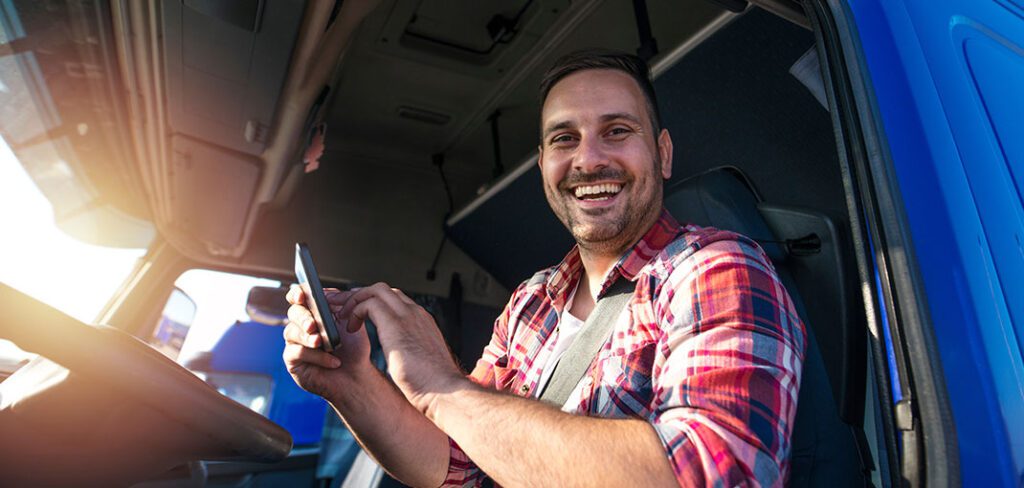 Truck driver with tablet using GPS navigation for his route.