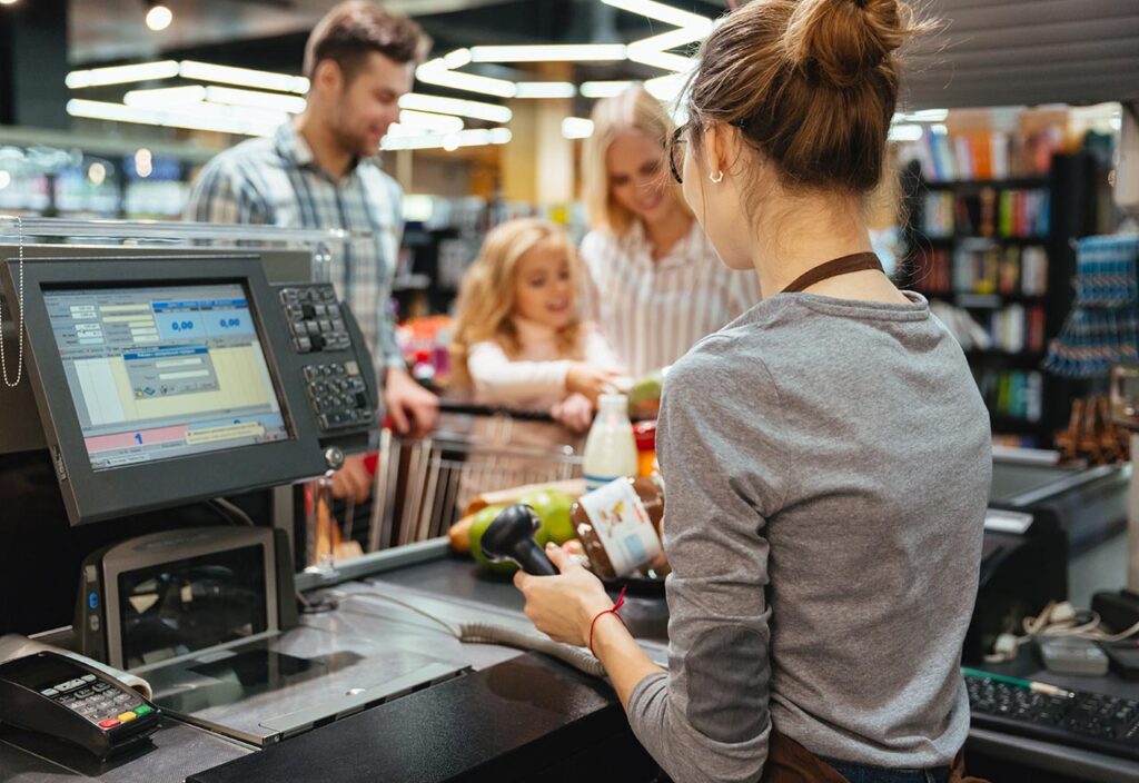 Beautiful family standing at the cash counter