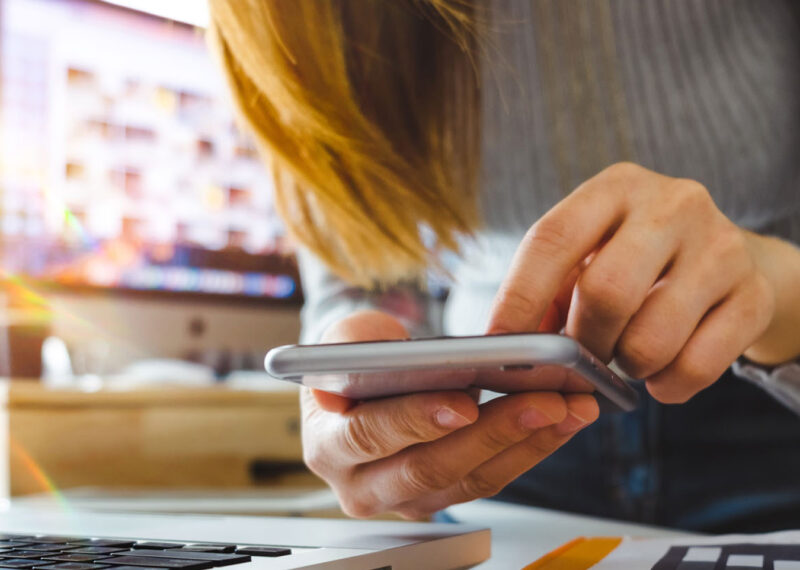 Retail customer inputting data into cloud on phone