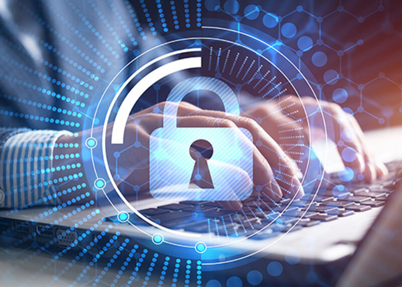 Man on computer with cybersecurity icon over image