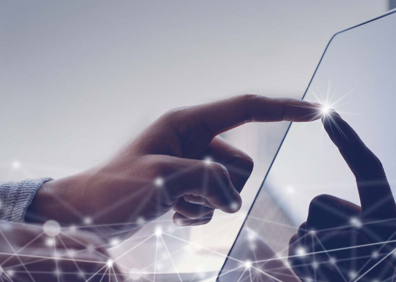 Close up of hand touching laptop screen