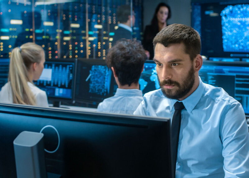 A focused man working on his computer at a data center