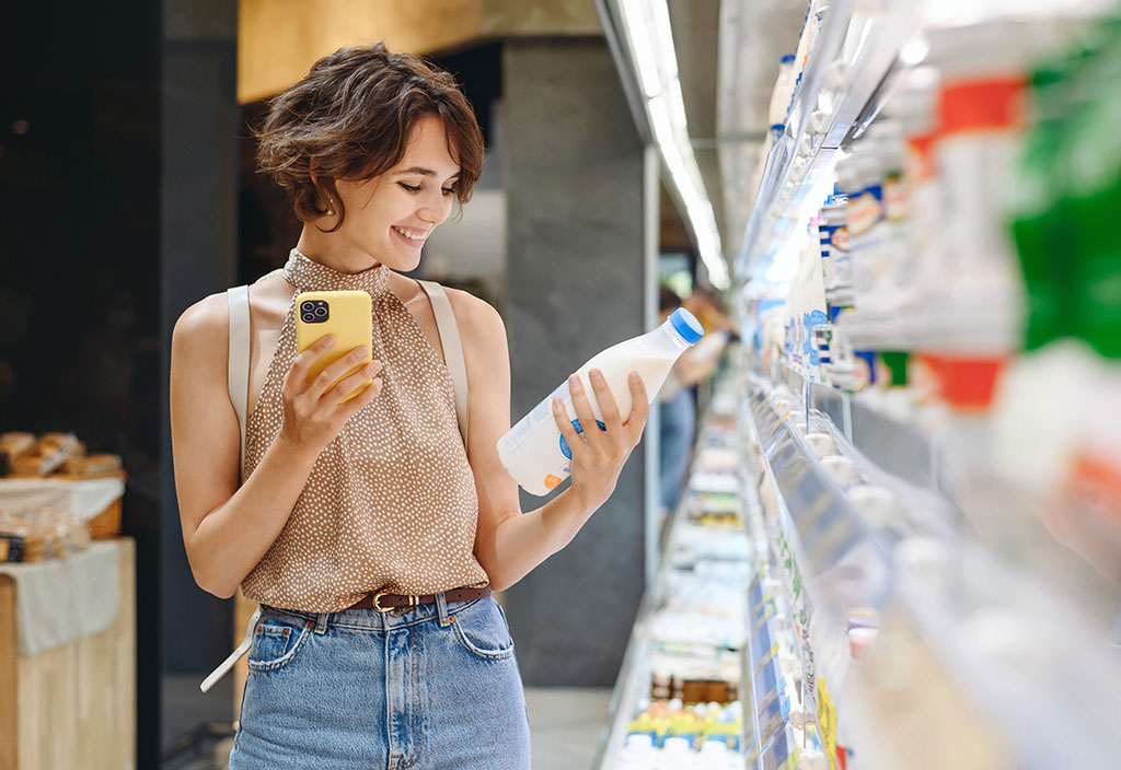 Two women working together sitting at a window.