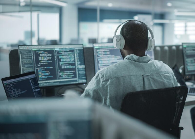 A developer writing code while listening to music