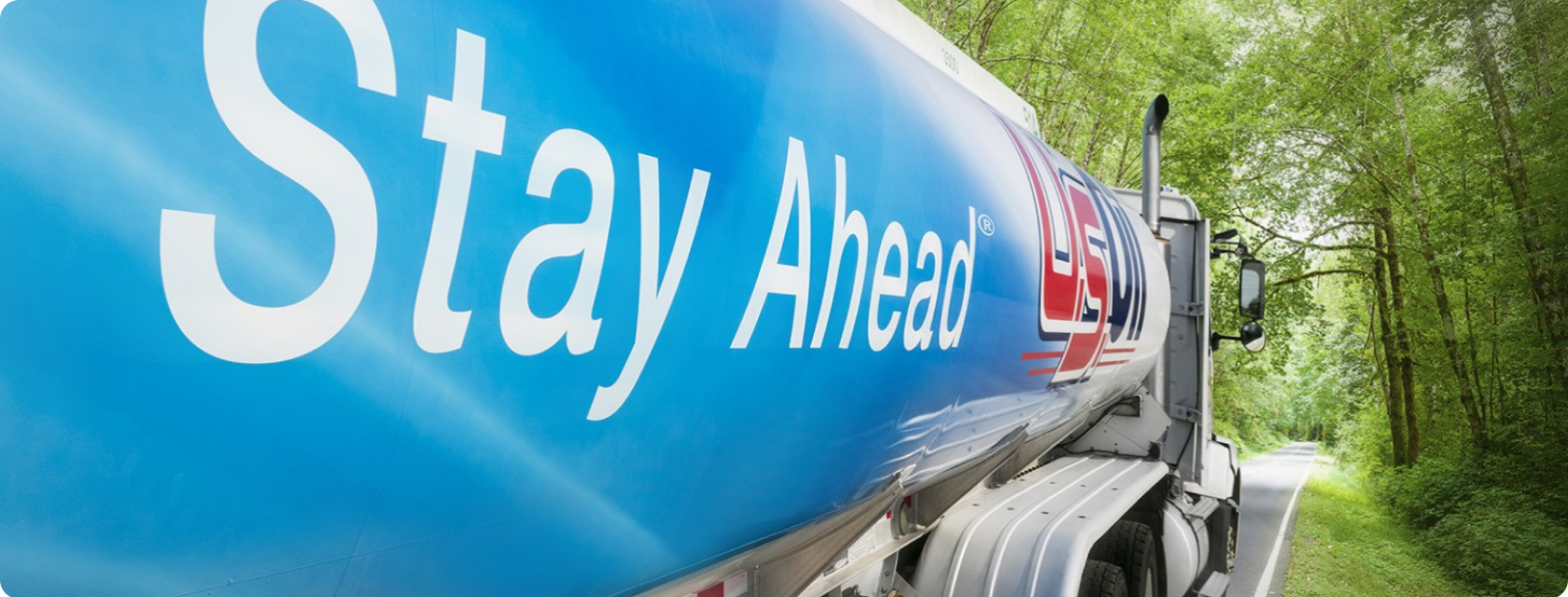 U.S. Oil fuel tanker driving down road with 