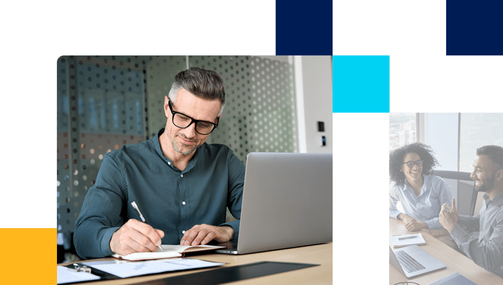 Two friendly professionals sitting together and laughing while working on a laptop 