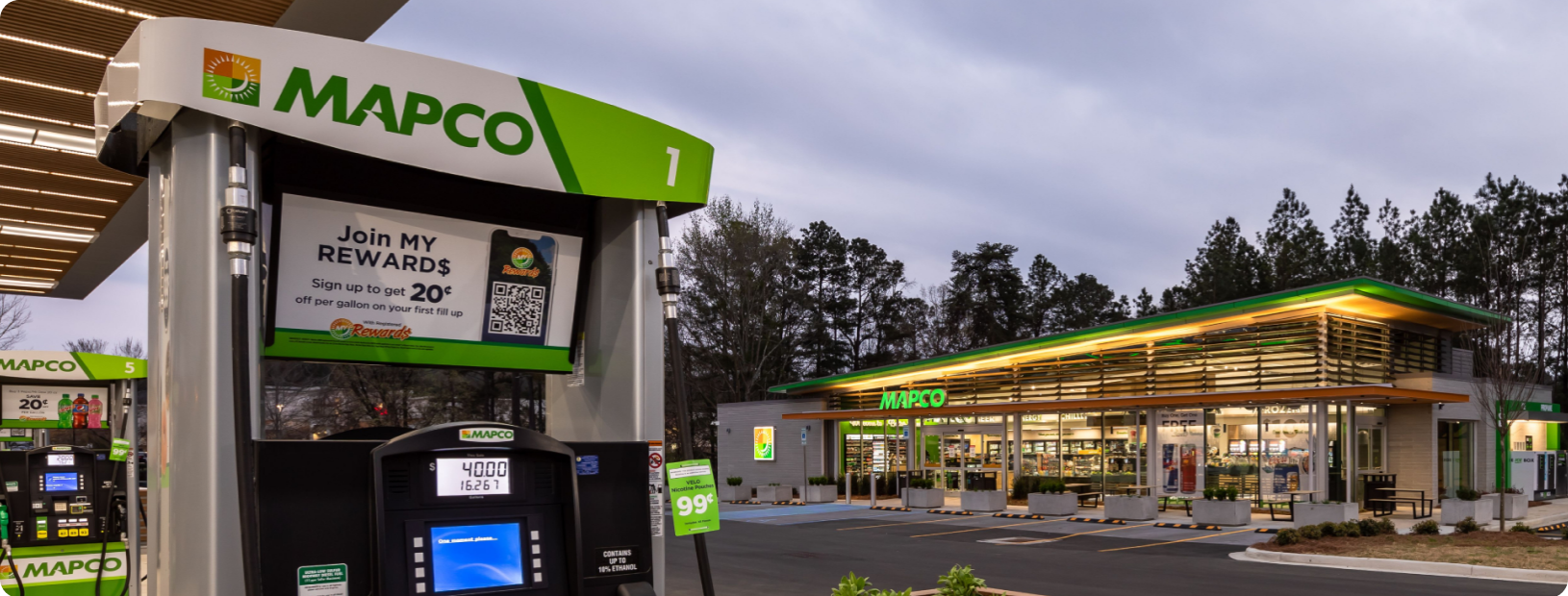 Wide-angle view of MAPCO convenience retail location in background and fuel pumps in foreground